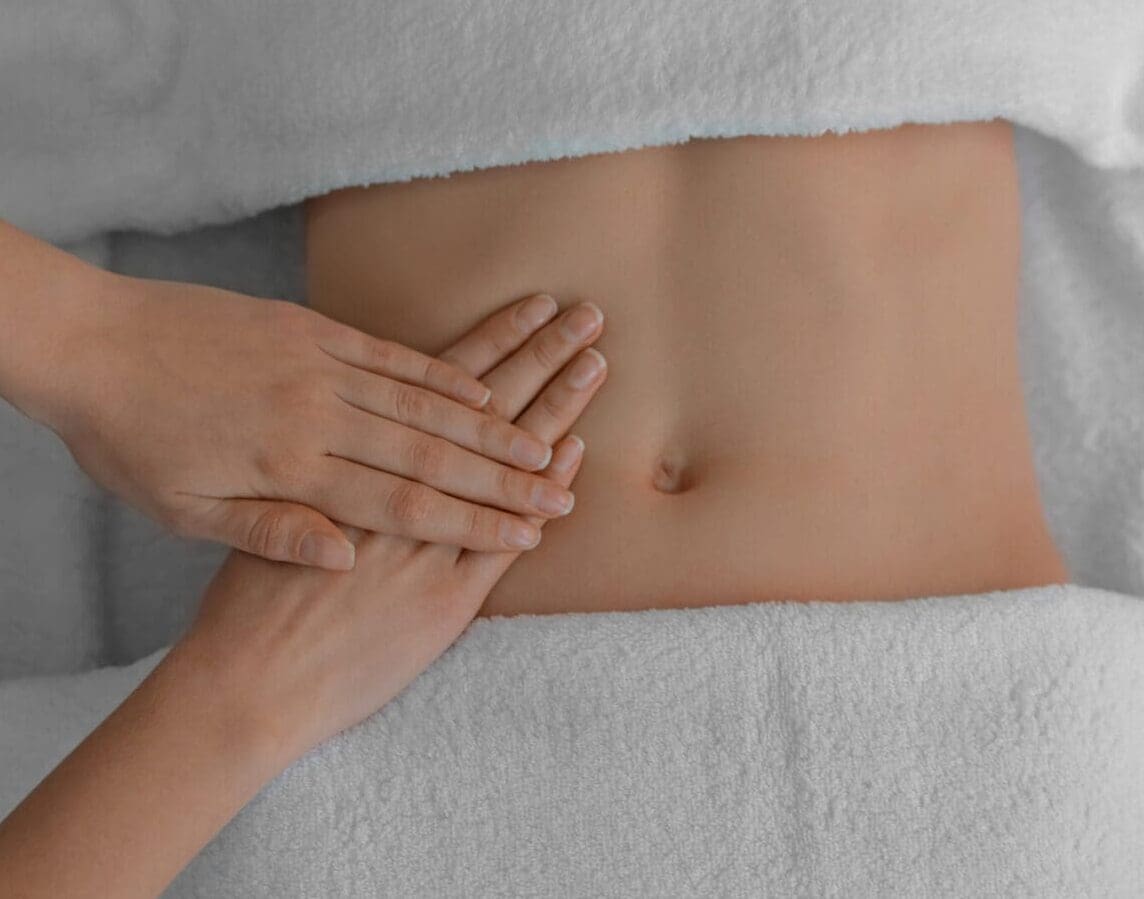 Woman receiving professional belly massage, closeup view